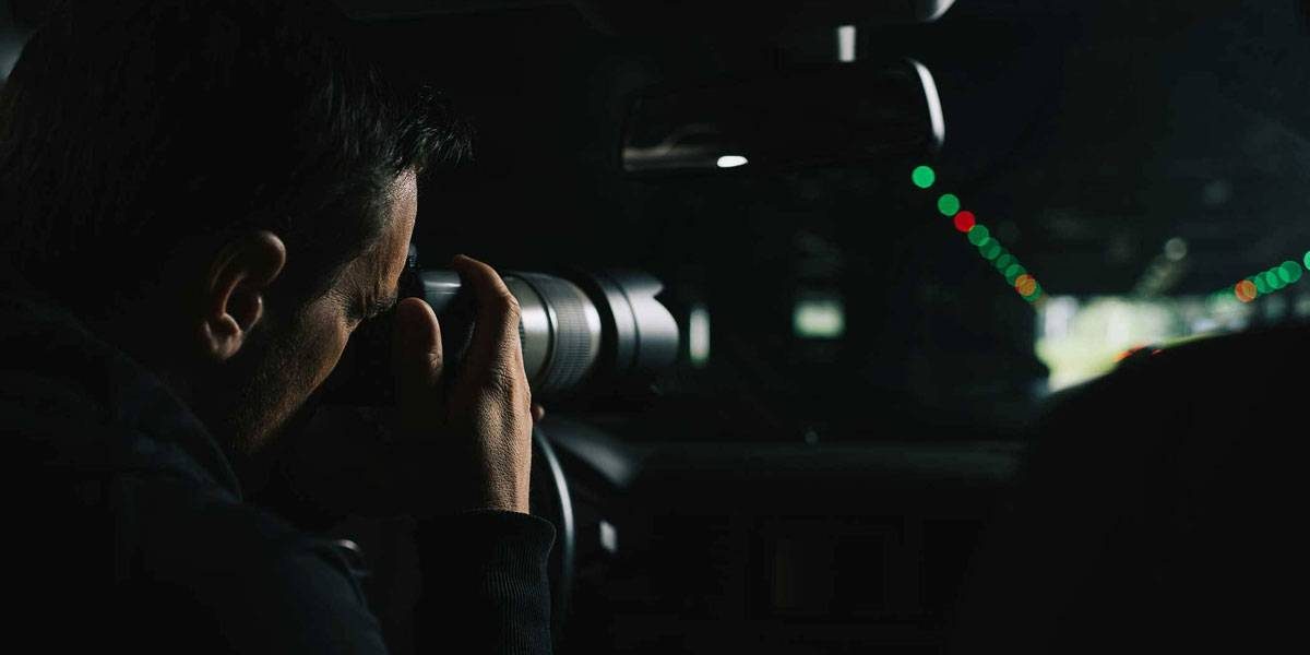 Male taking mysterious photo from his car in the dark